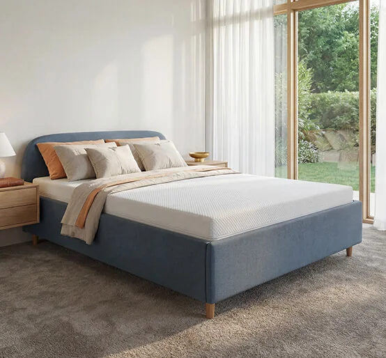 Dormeo Essence mattress on a blue upholstered bed frame