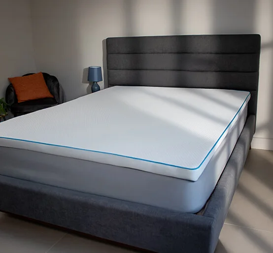 Dormeo Octasmart Essentials Cooling Mattress Topper on a divan bed