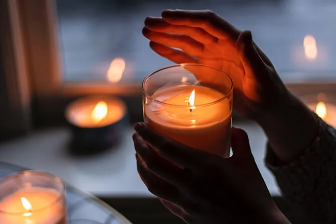 Person holding a scented candle