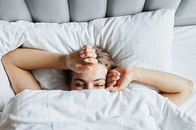 Woman under the duvet