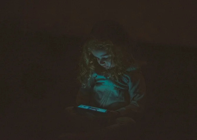 child on phone at night