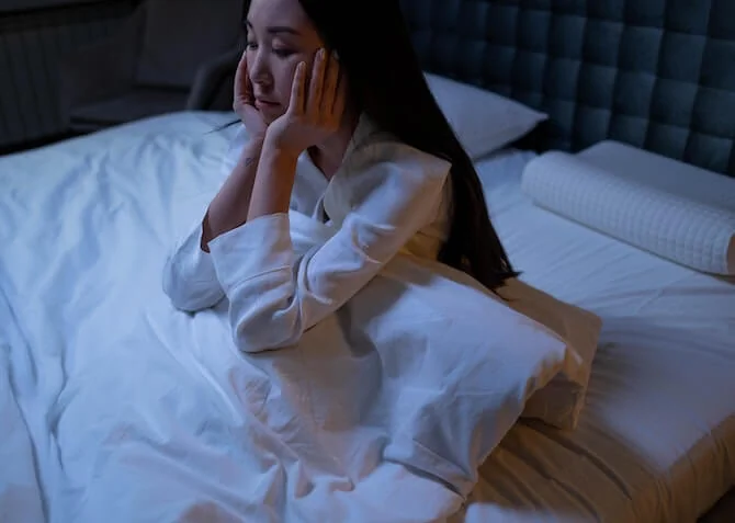 woman in bed with sleep deprivation