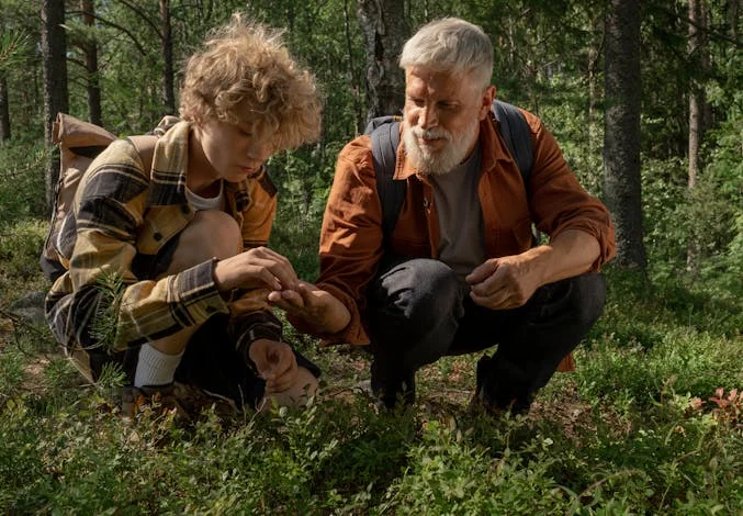 a man with his grandson in the woods