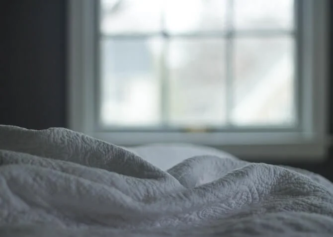 soft bedding with window in the background