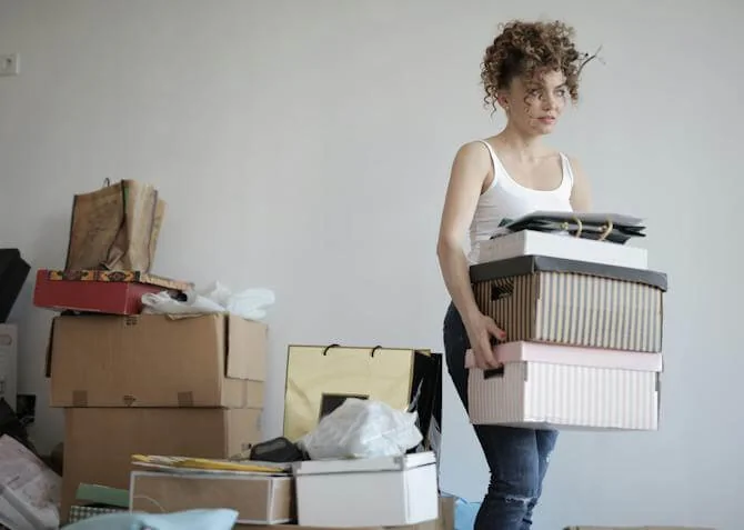 woman decluttering her bedroom