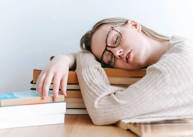 woman having a sneaky nap while working from home