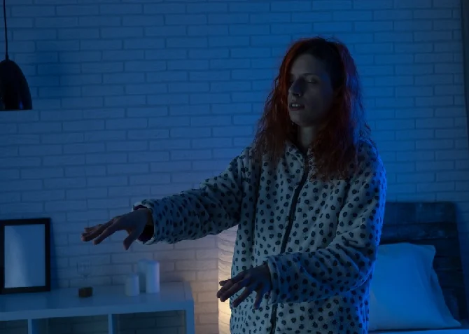 woman sleep walking in her bedroom at night