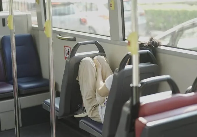 woman sleeping on a bus
