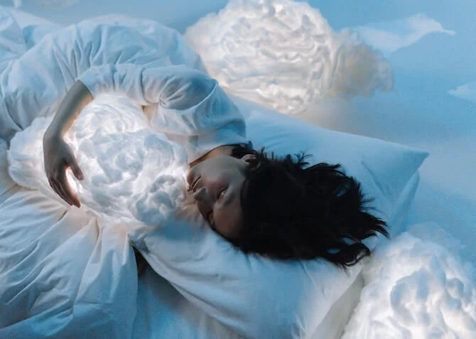 woman sleeping with a cloud in her arms