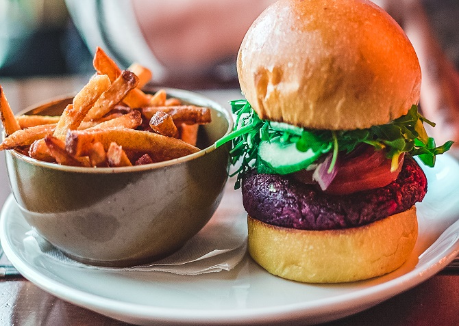 A plant-based burger and fries on a plate