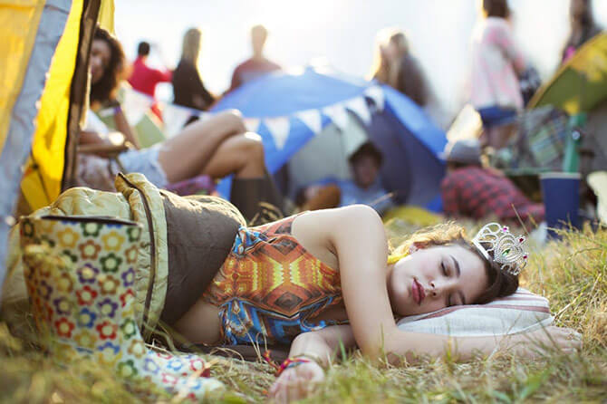 Girl napping outside at a music festival