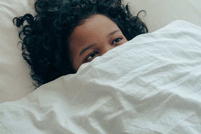 woman under duvet keeping warm