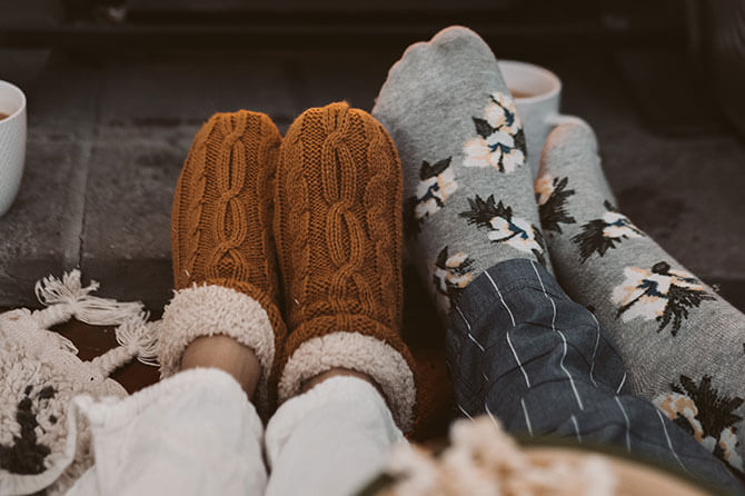 Couple wearing winter socks and slippers