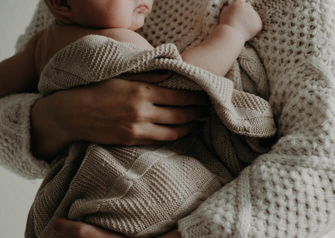 baby kept warm in blanket