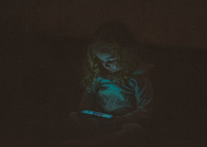 child on phone at night