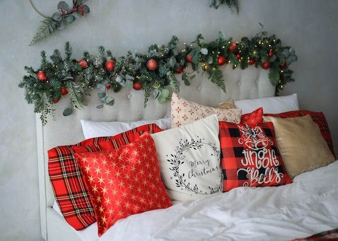 Christmas pillows on a bed