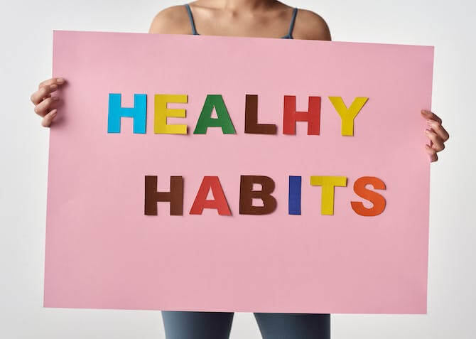 a healthy habits sign being held up