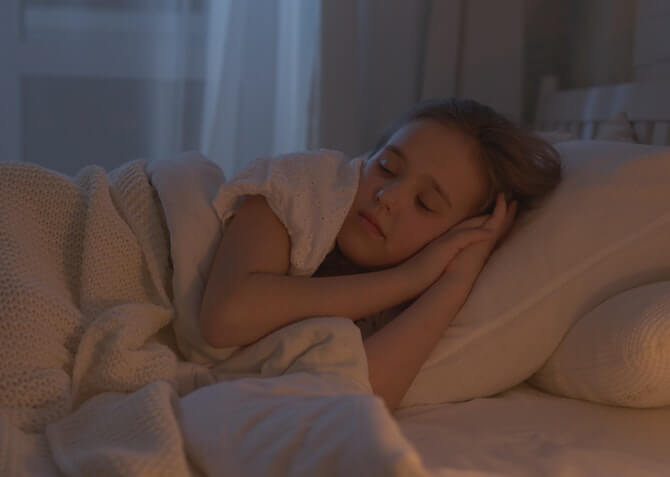 kid sleeping well on a comfy bed