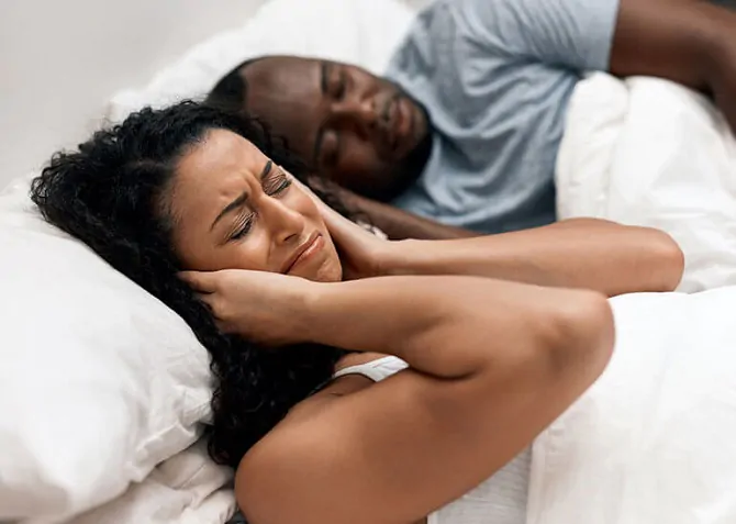 snoring man and unhappy wife