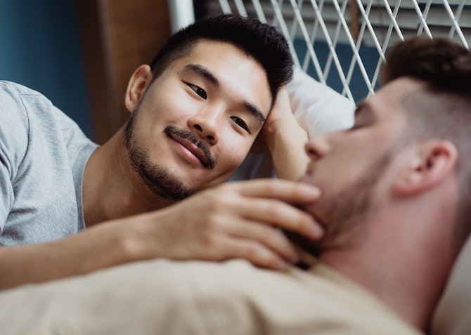 couple looking at each other in bed