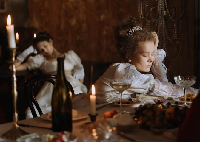 royals sitting at dining table looking tired