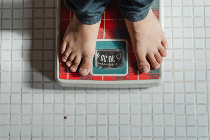 person standing on weighing scales