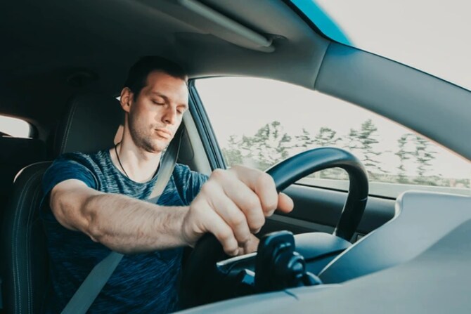 tired driver falling asleep at the wheel