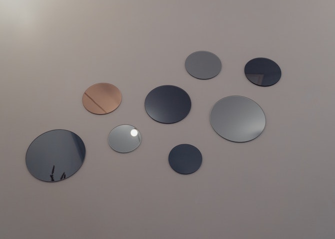 circular mirrors on a wall