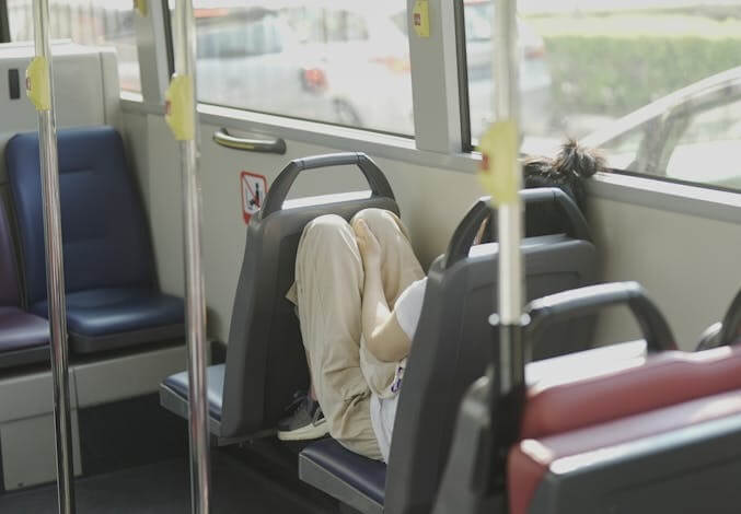 woman sleeping on a bus