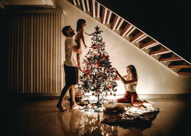 young family decorating the Christmas tree
